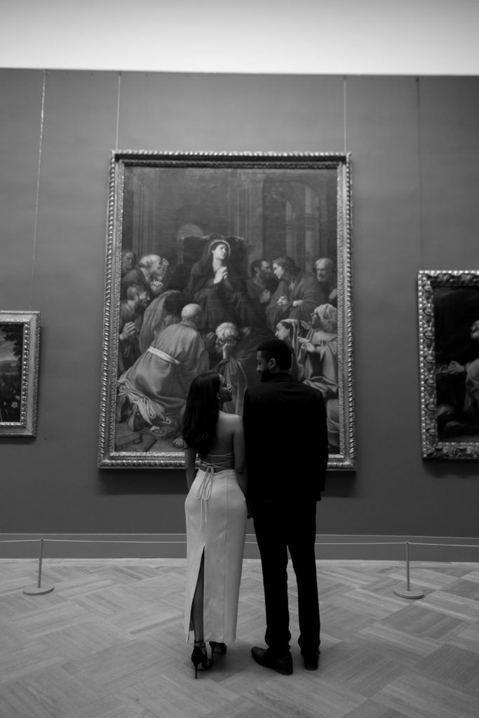 man and woman looking at eachother during their engagement session at the met
